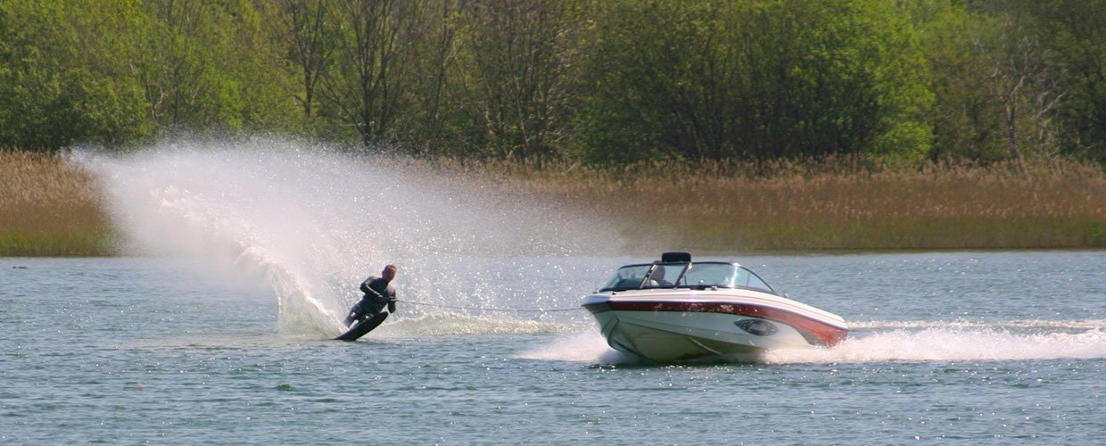 skier behind jet boat on lake